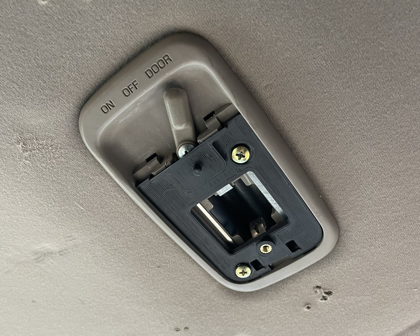 1st step of install is to attach our baseplate to factory switch panel using the gold factory Phillips head screws