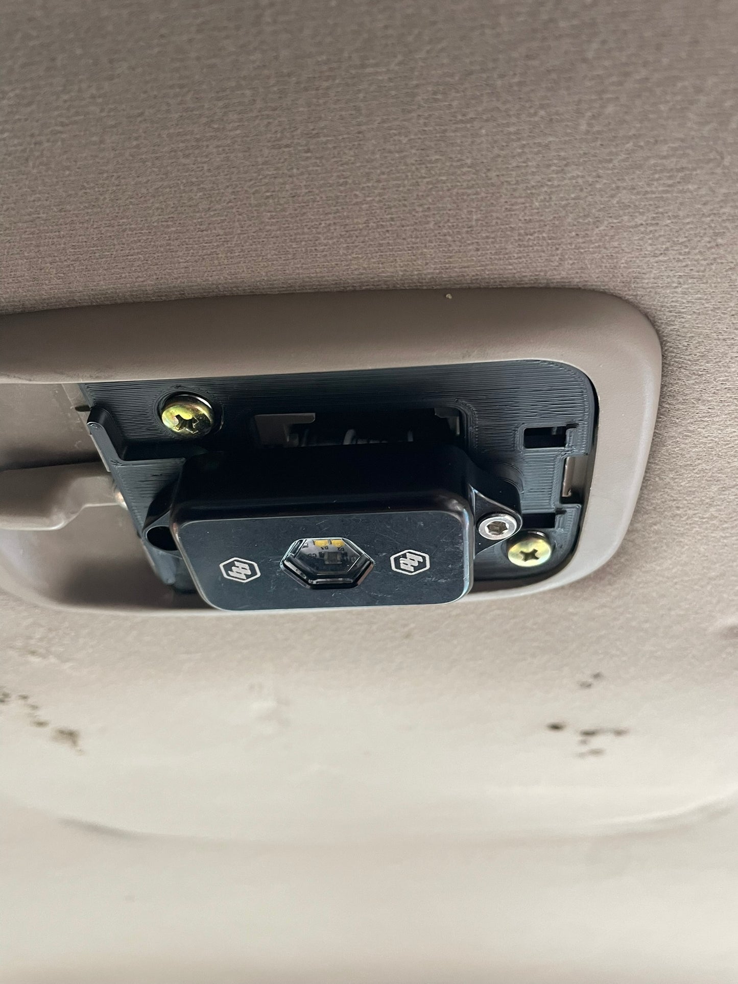 BD partially installed. Use factory Phillips head screws to attach base to the factory switch plate. Then use an m4 screw from included mounting hardware from BD to attach light to my base. Gently tuck wires between BD light and festoon bulb. No need for long wires