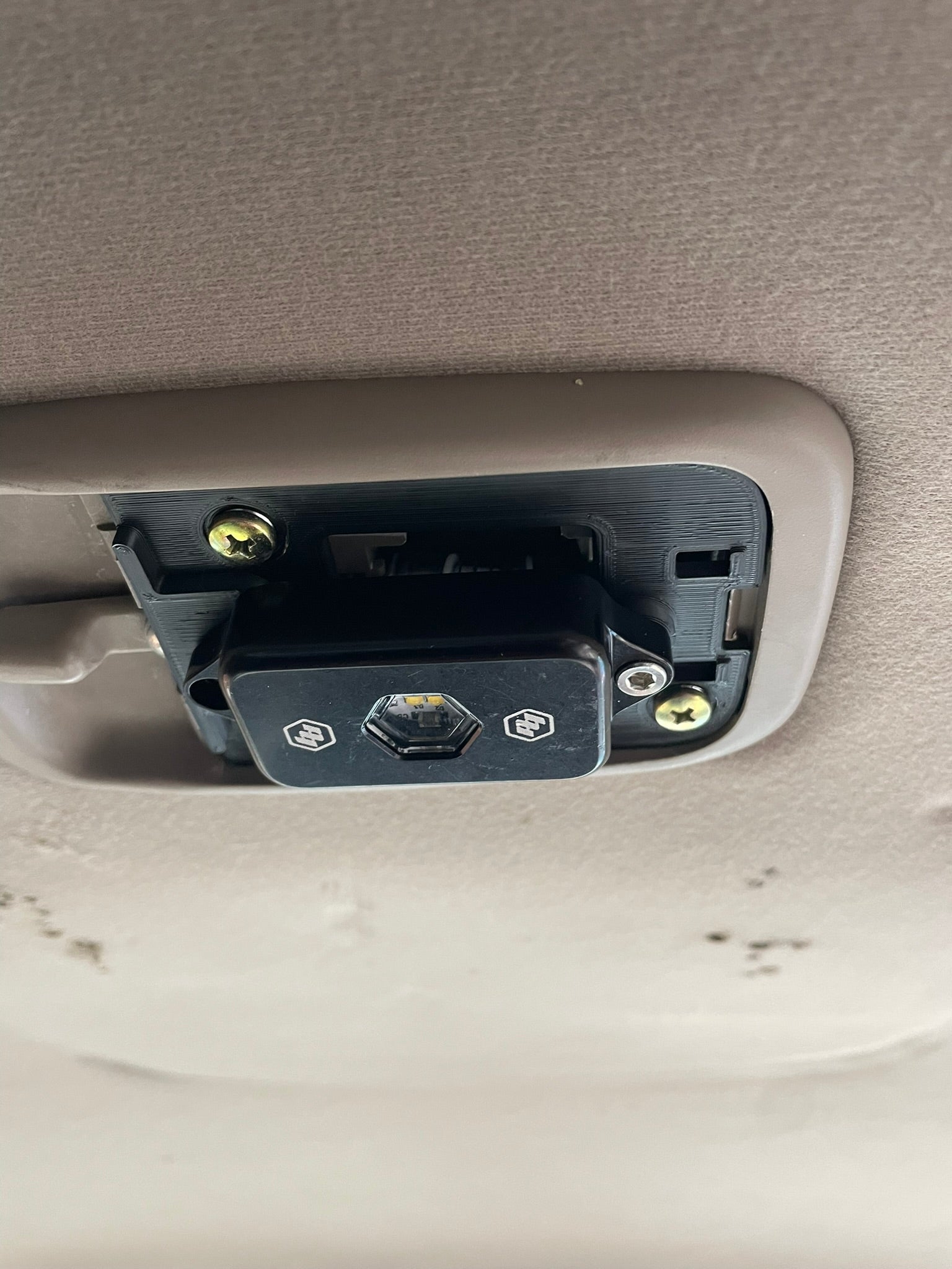 BD partially installed.  Use factory Phillips head screws to attach base to the factory switch plate. Then use an m4 screw from included mounting hardware from BD to attach light to my base. Gently tuck wires between BD light and festoon bulb. No need for long wires